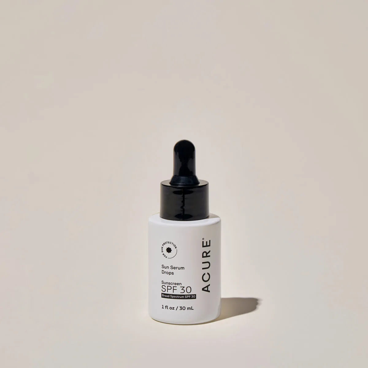 Acure Sun Serum Drops SPF 30 bottle on white background