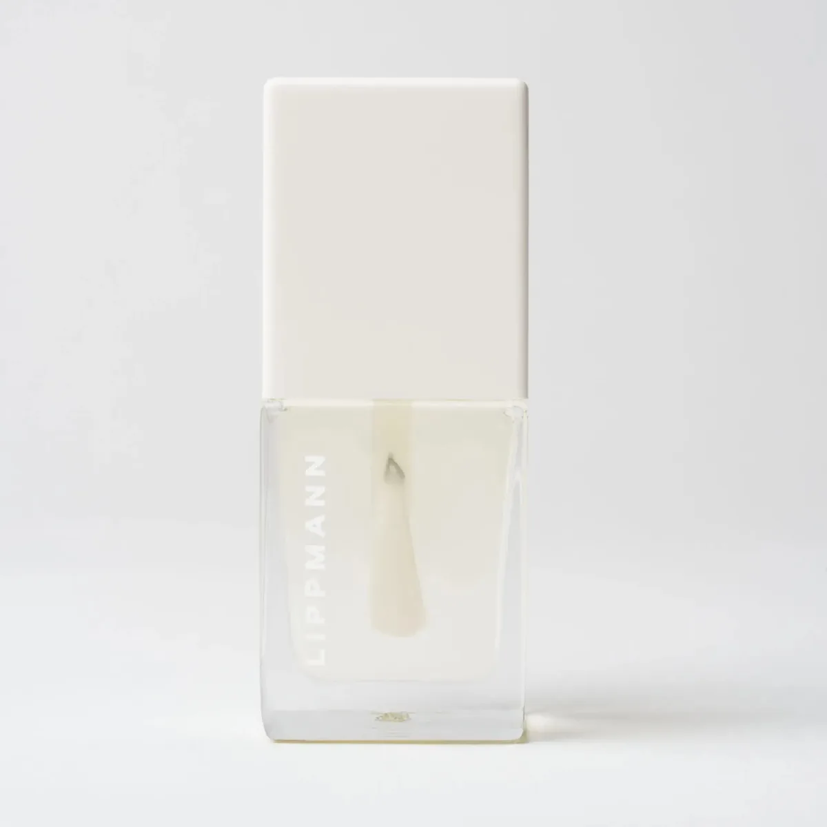 Deborah Lippmann Hydrating Vitamin E Oil in a clear square glass bottle with a white LIPPMANN cap and brush applicator