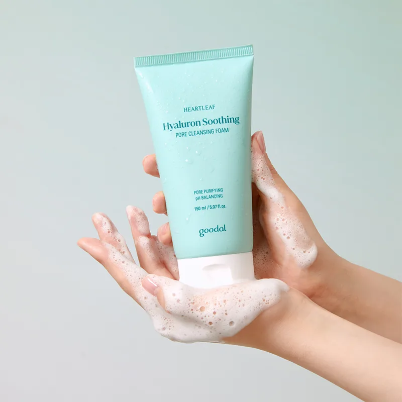 Goodal Heartleaf Hyaluron Soothing Pore Cleansing Foam 150 mL mint tube held in lathered hands