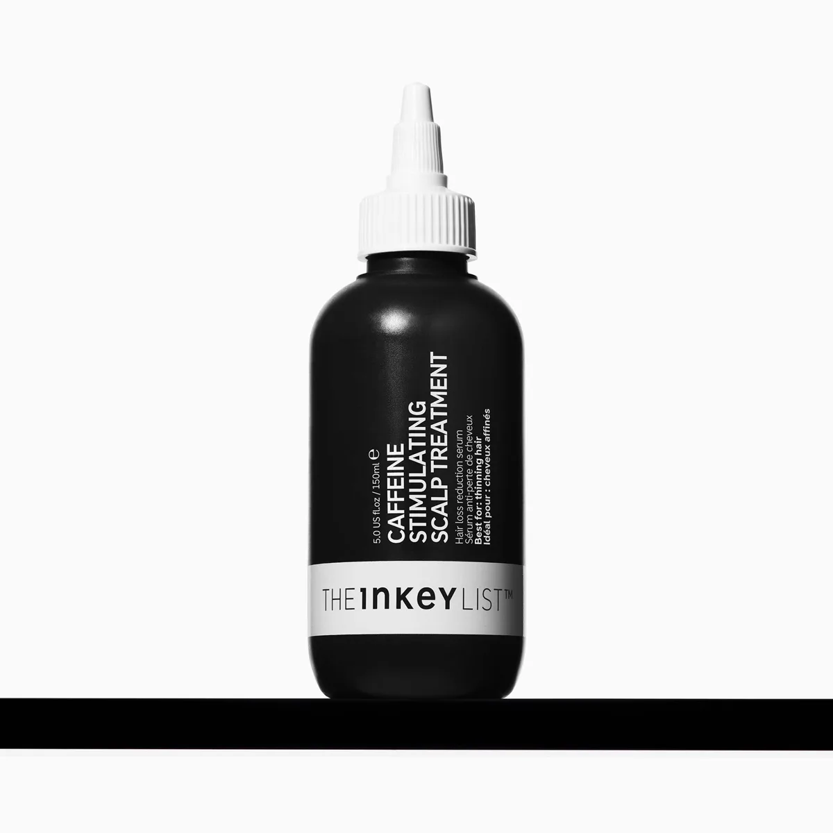 The INKEY List Caffeine Stimulating Scalp Treatment in a black squeeze bottle with a white pointed nozzle, 150 ml
